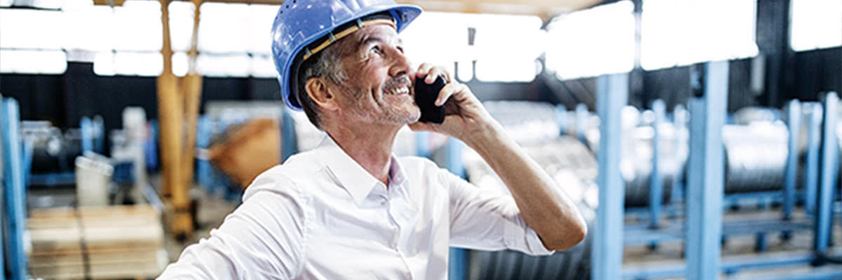 Man in hardhat using cell phone