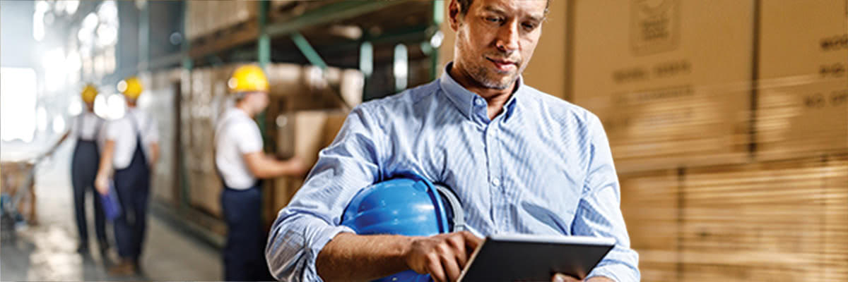 Man with hardhat using tablet